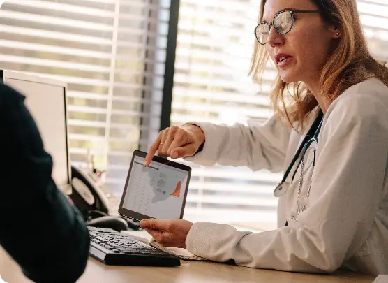 Female doctor showing to its patient data on a tablet